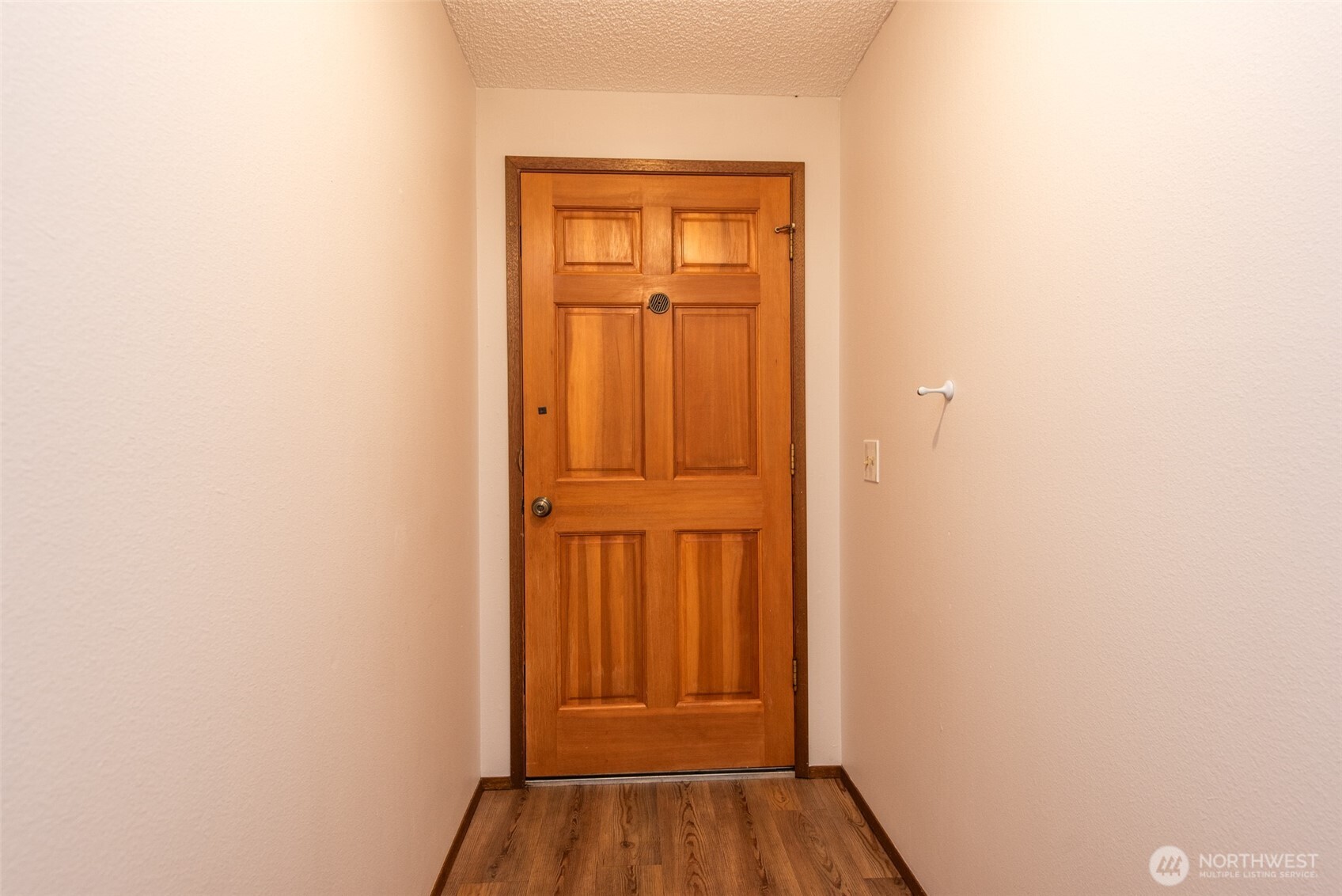 1301 South 3rd Avenue, Unit 19D Sequim, WA 98382 - Photo 5 of 35 a view of a hallway with wooden floor