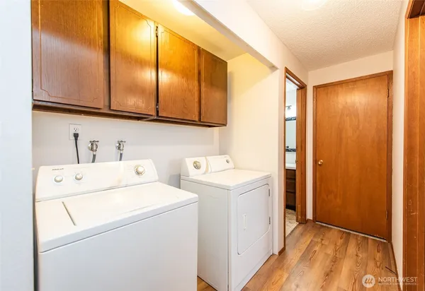 a view of washer and dryer with kitchen view