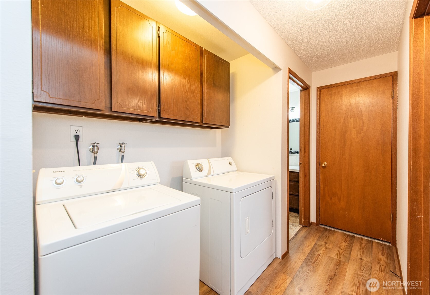 1301 South 3rd Avenue, Unit 19D Sequim, WA 98382 - Photo 8 of 35 a view of washer and dryer with kitchen view
