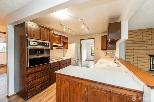 a kitchen with stainless steel appliances a refrigerator and cabinets