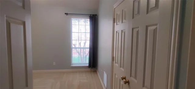 a view of a hallway with windows