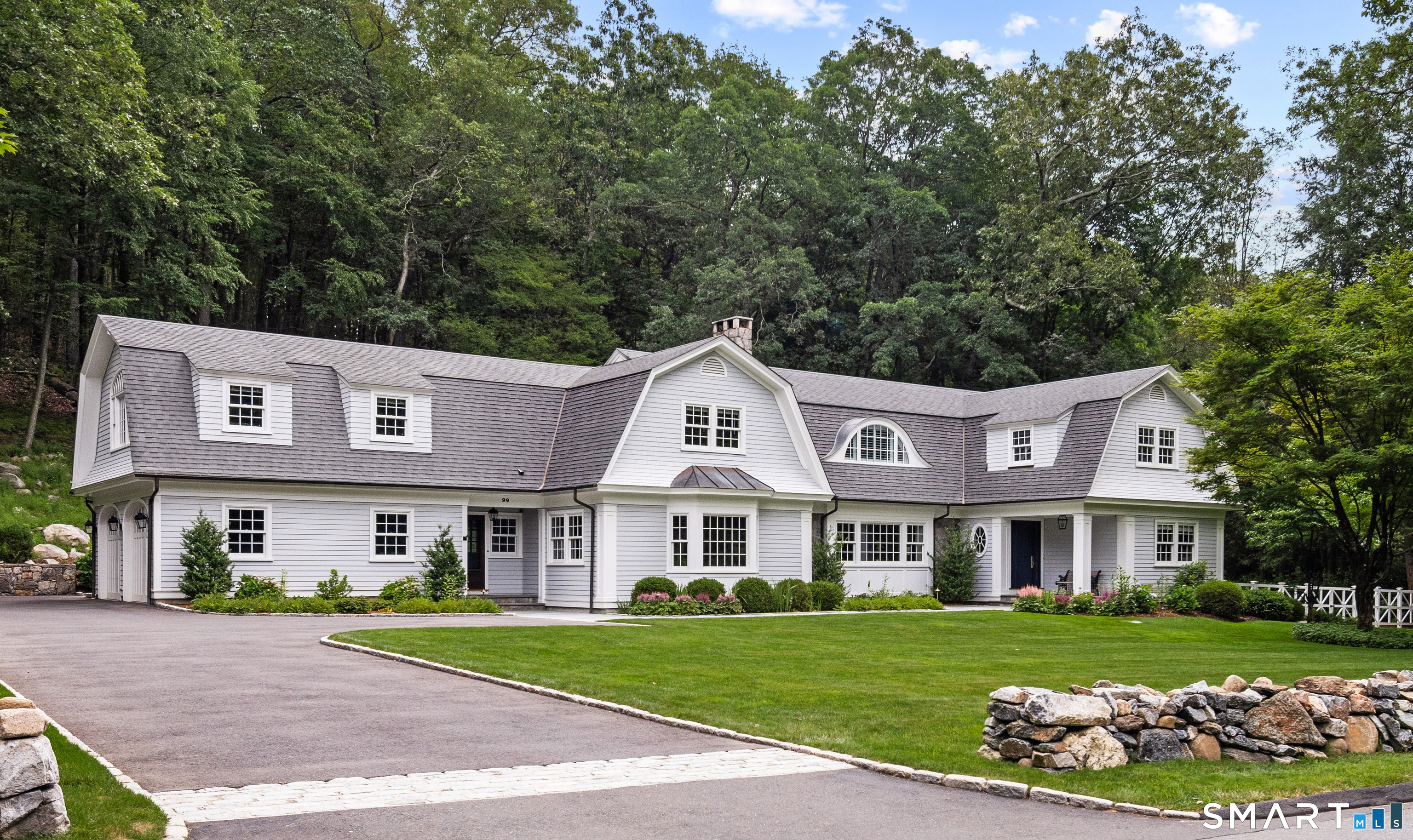 99 Hickok Road New Canaan, CT 06840 - Photo 1 of 39 a front view of a residential houses with yard and green space