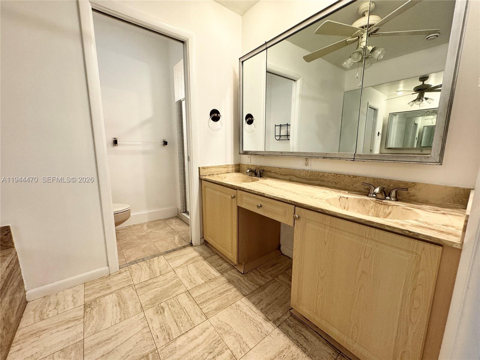 2001 St Andrews Road, Unit 121 Hollywood, FL 33021 - Photo 23 of 39 a spacious bathroom with a granite countertop sink a mirror and a shower
