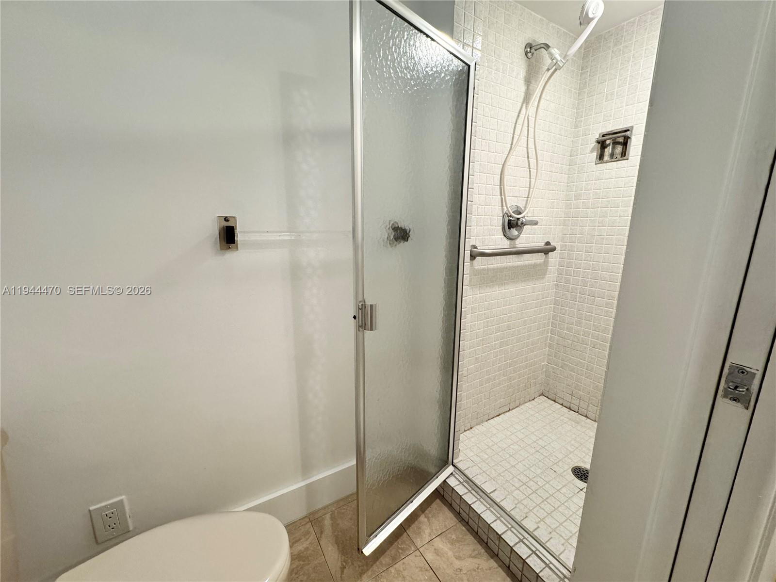 2001 St Andrews Road, Unit 121 Hollywood, FL 33021 - Photo 24 of 39 a bathroom with a toilet and a shower