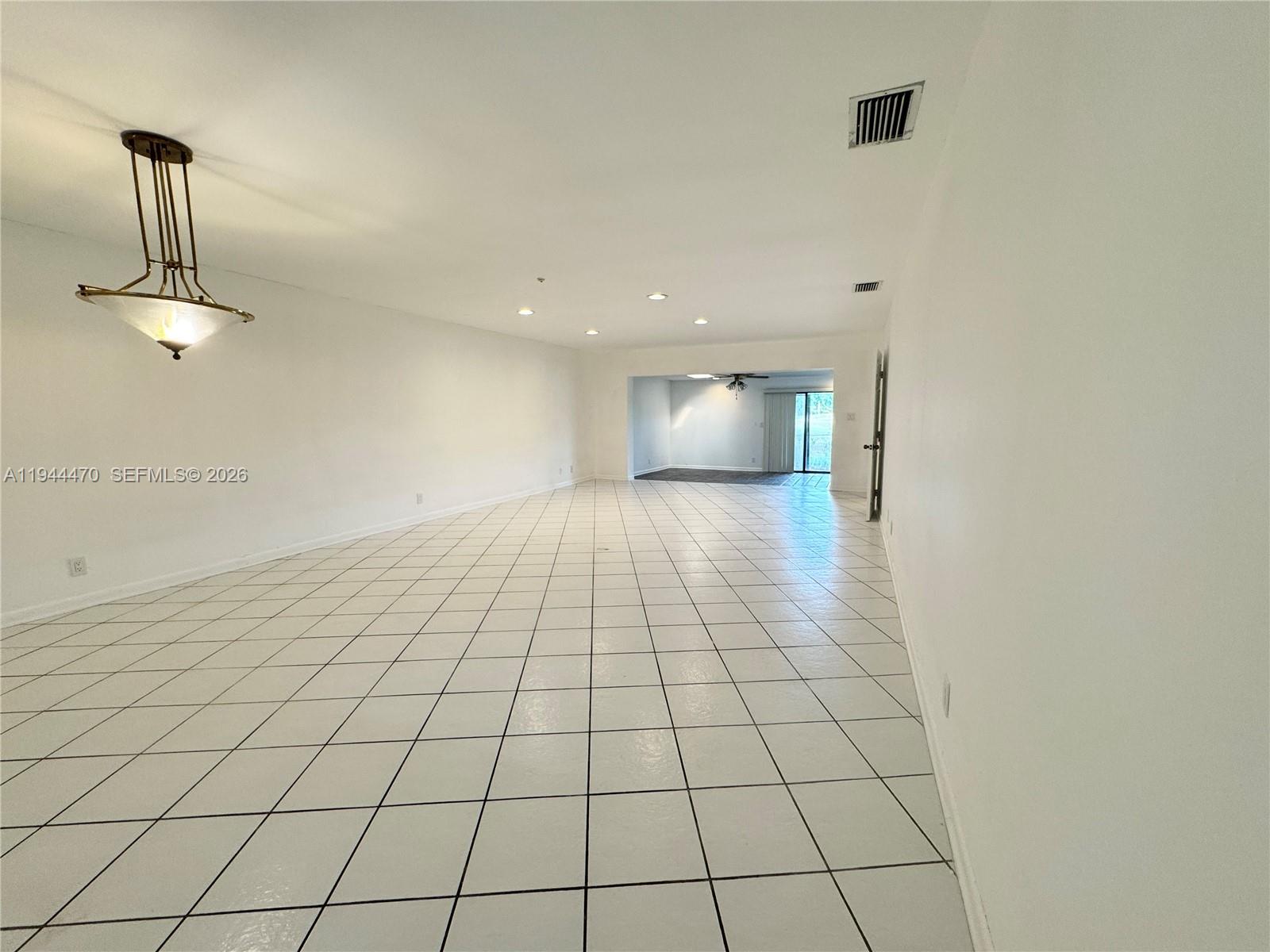 2001 St Andrews Road, Unit 121 Hollywood, FL 33021 - Photo 31 of 39 a view of an empty room and chandelier fan