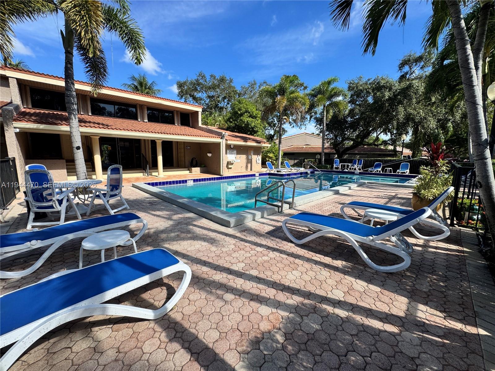 2001 St Andrews Road, Unit 121 Hollywood, FL 33021 - Photo 39 of 39 a view of a house with pool and chairs