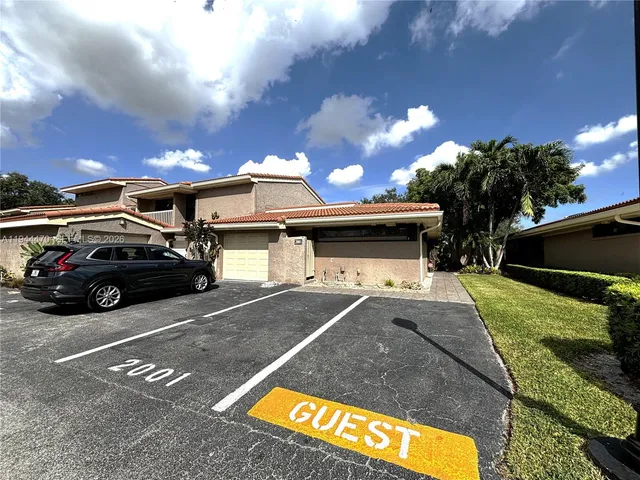 a view of a car park in front of house