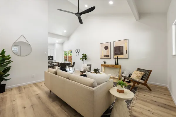 a kitchen with stainless steel appliances a stove a sink cabinets and wooden floor