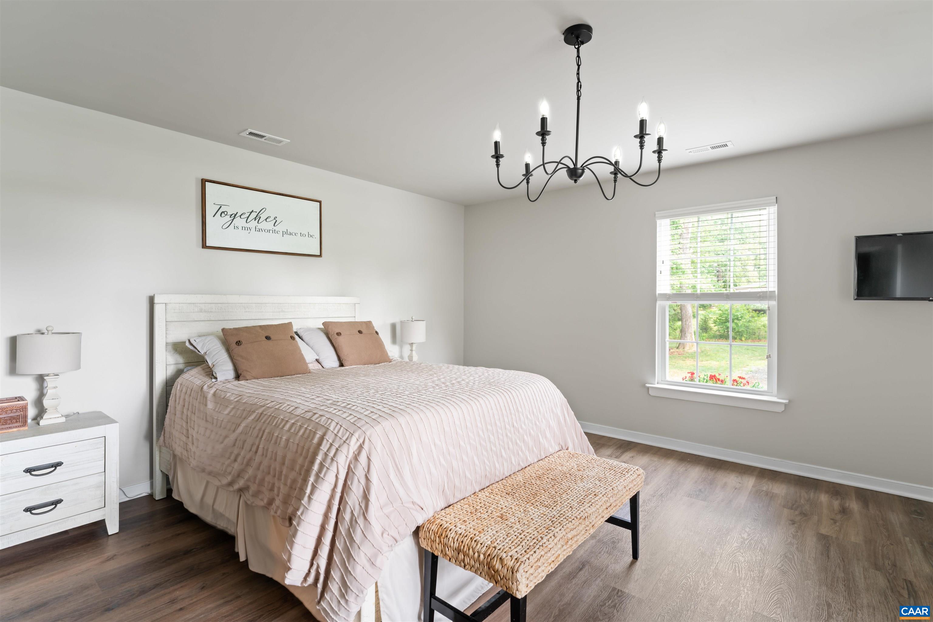 1760 Haden Martin Road Palmyra, VA 22963 - Photo 29 of 51 a spacious bedroom with a bed chandelier and window