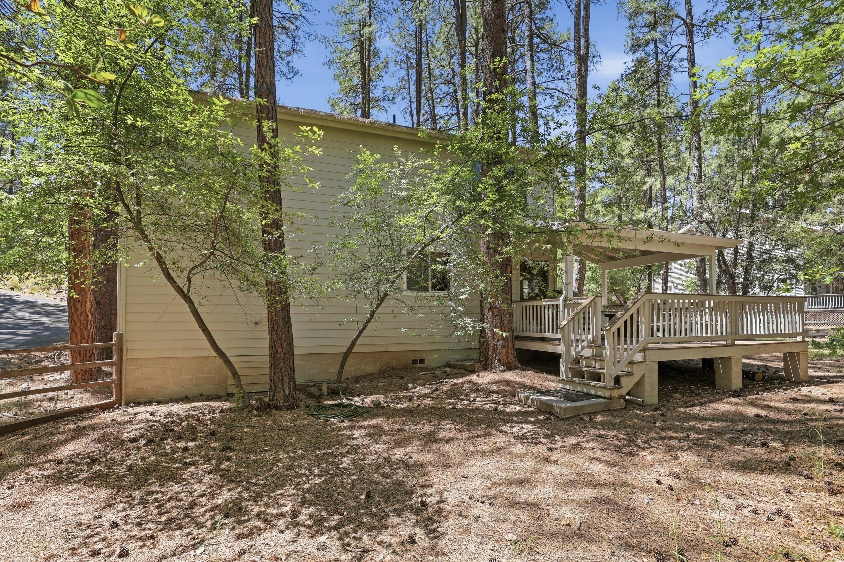 6322 Sharyn Road Pine, AZ 85544 - Photo 28 of 37 a view of a brick house with a yard