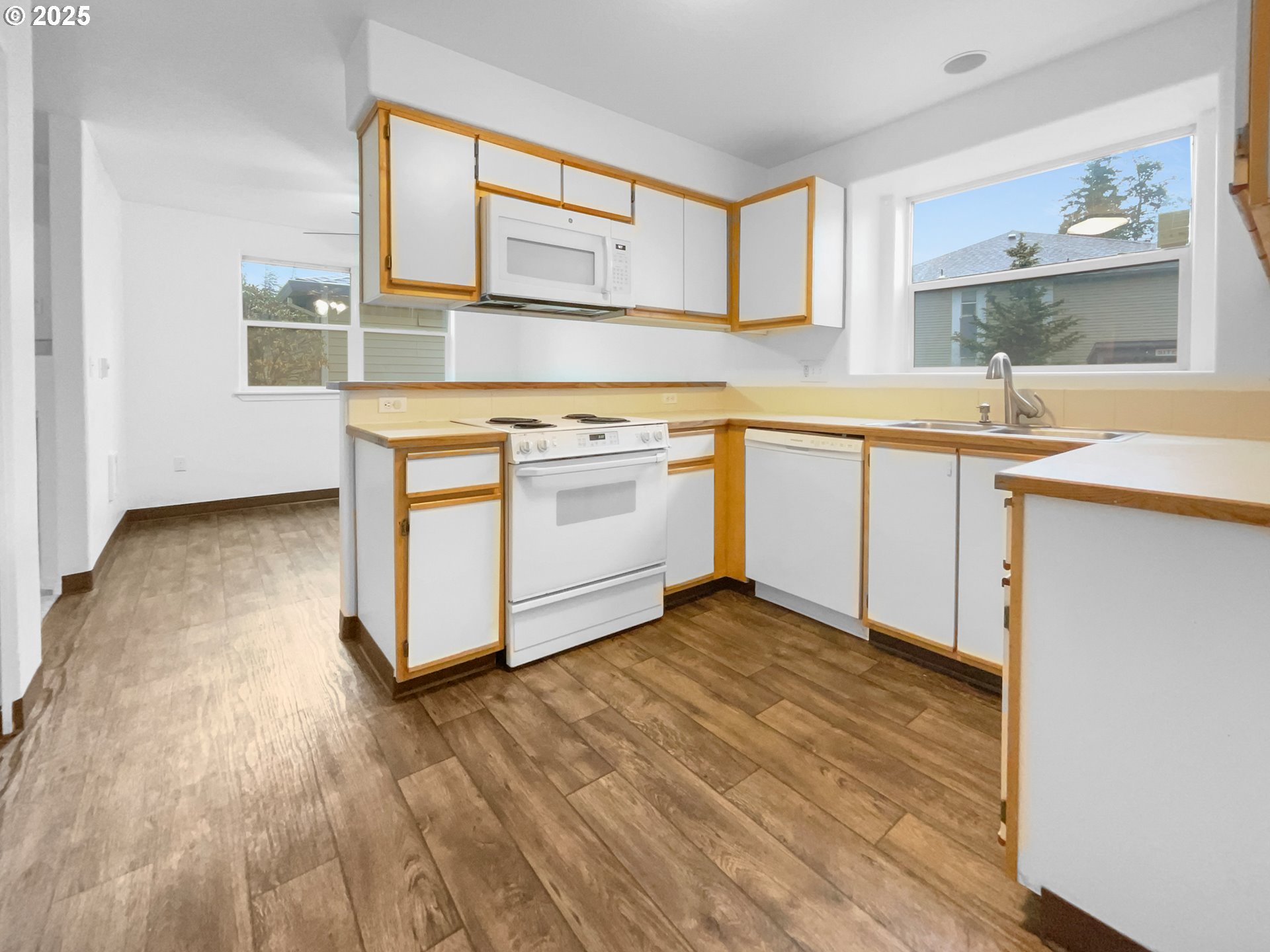 4606 West Powell Boulevard, Unit 163 Gresham, OR 97030 - Photo 14 of 19 a kitchen with stainless steel appliances granite countertop a stove a sink and a microwave