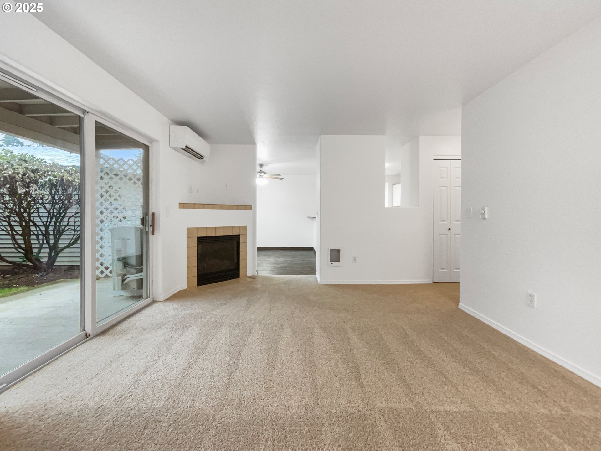 4606 West Powell Boulevard, Unit 163 Gresham, OR 97030 - Photo 3 of 19 a view of an empty room with a fireplace and a window