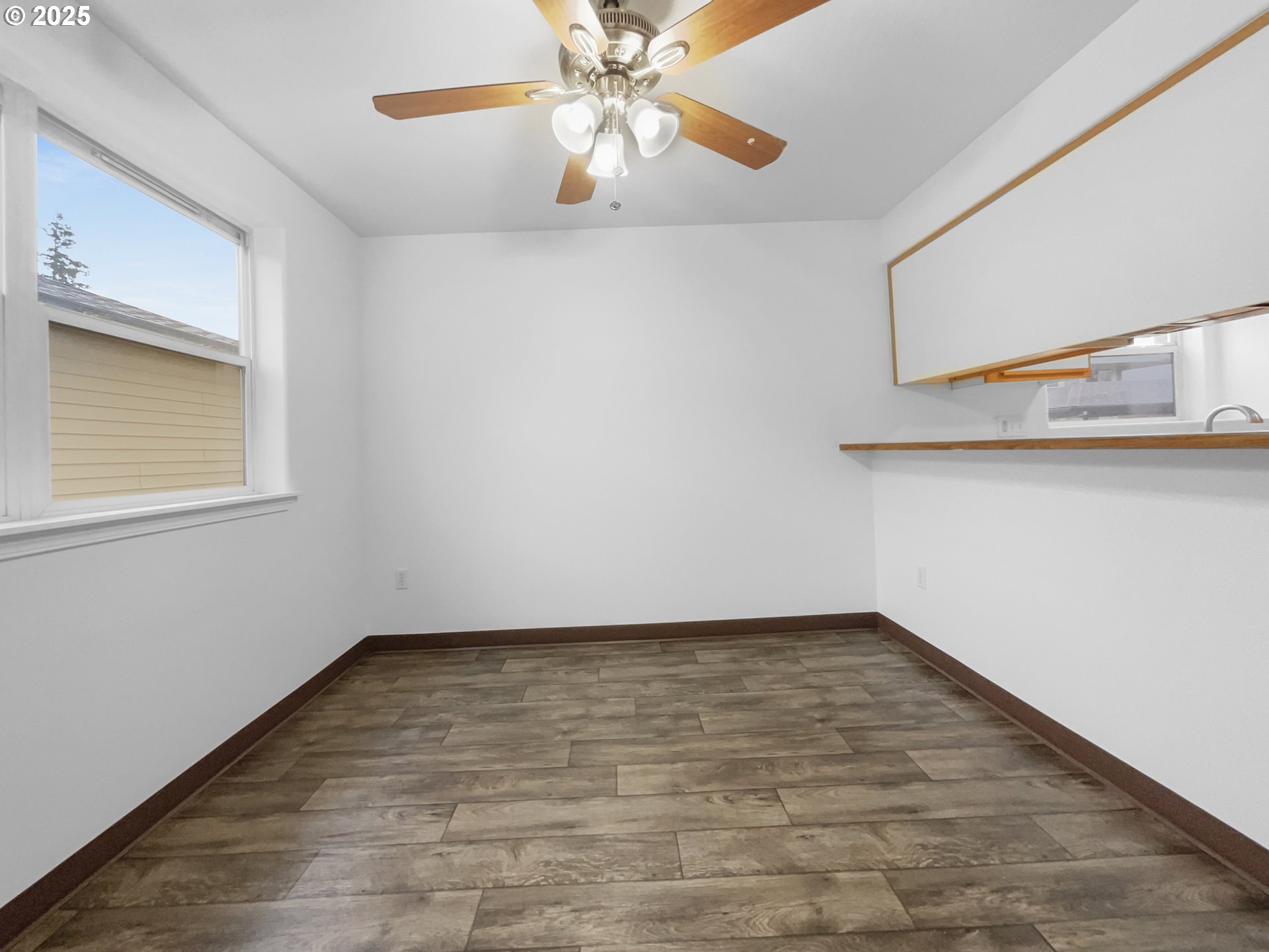 4606 West Powell Boulevard, Unit 163 Gresham, OR 97030 - Photo 5 of 19 a view of an empty room with window and wooden floor