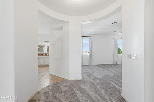 a bathroom with a double vanity sink a toilet and shower