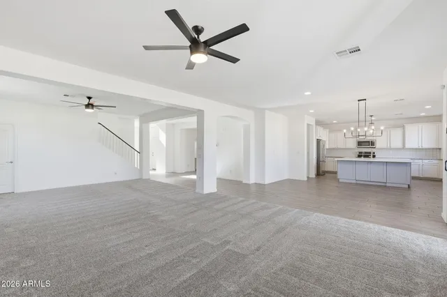 a view of a room with a ceiling fan