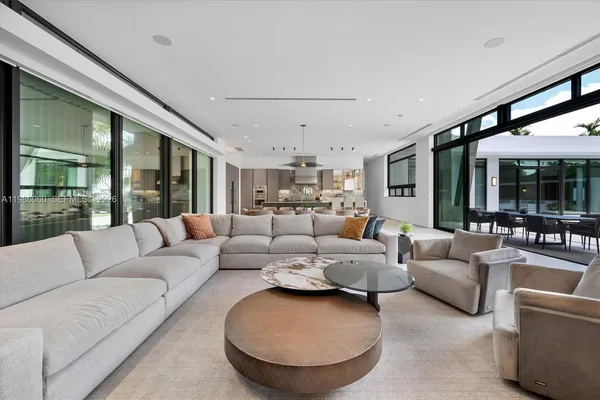 a kitchen with stainless steel appliances kitchen island granite countertop a table and chairs in it