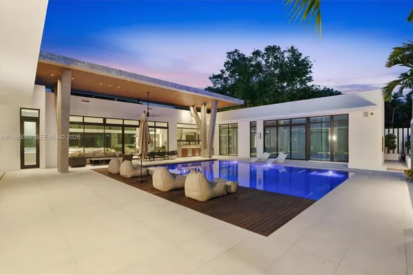 a view of a swimming pool with outdoor seating