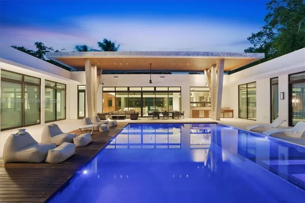 a view of a house with swimming pool and a chairs