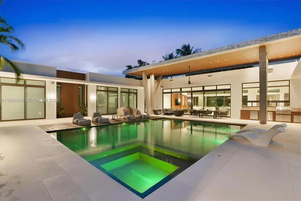 a front view of a house with yard and green space
