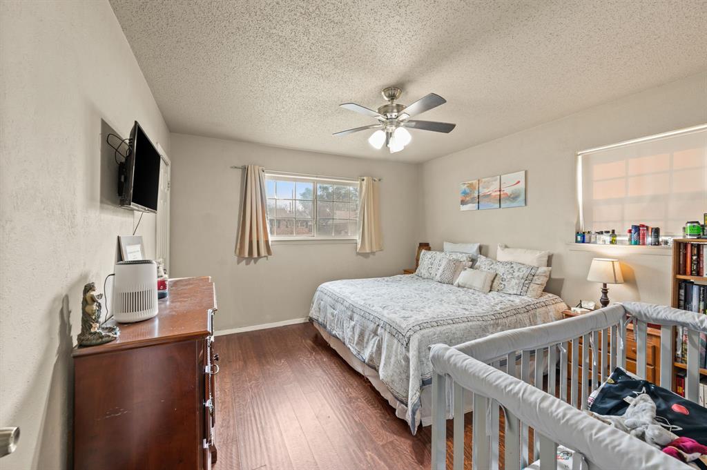 2125 Shady Brook Drive Bedford, TX 76021 - Photo 11 of 24 a bedroom with furniture and a flat screen tv