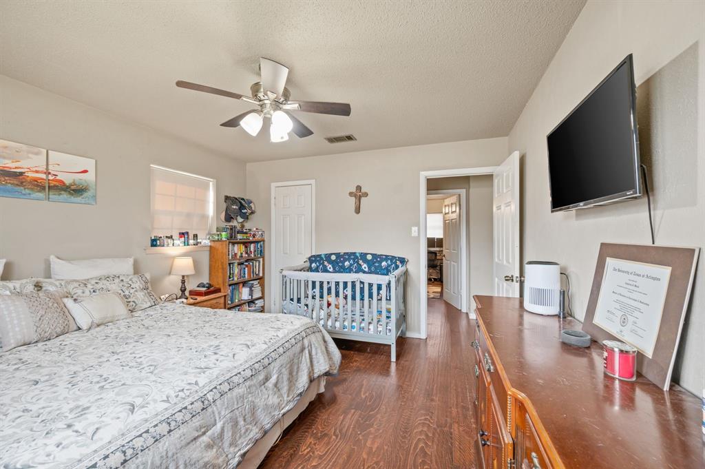 2125 Shady Brook Drive Bedford, TX 76021 - Photo 12 of 24 a bedroom with a bed and a flat screen tv