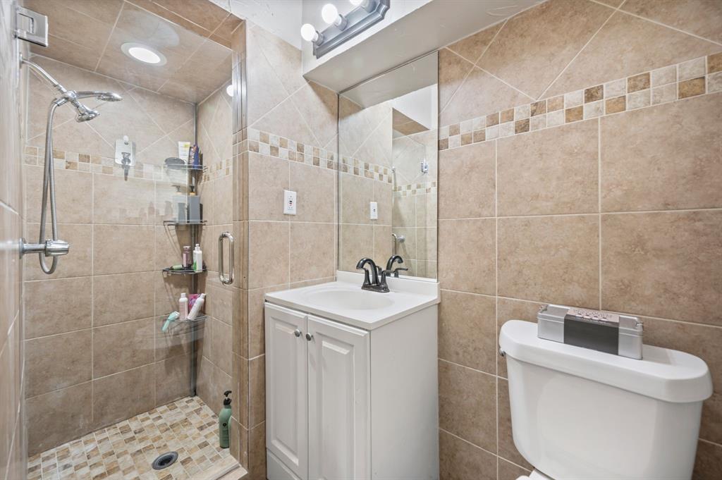 2125 Shady Brook Drive Bedford, TX 76021 - Photo 13 of 24 a bathroom with a sink a toilet and shower