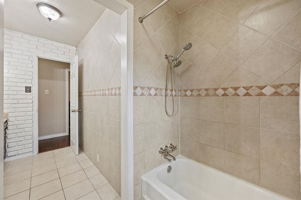 2125 Shady Brook Drive Bedford, TX 76021 - Photo 17 of 24 a bathroom with a bathtub and shower