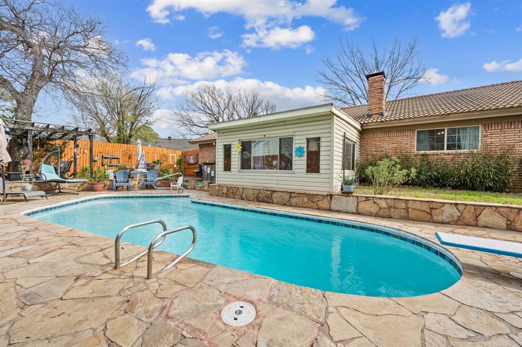 2125 Shady Brook Drive Bedford, TX 76021 - Photo 22 of 24 a swimming pool with outdoor seating and yard