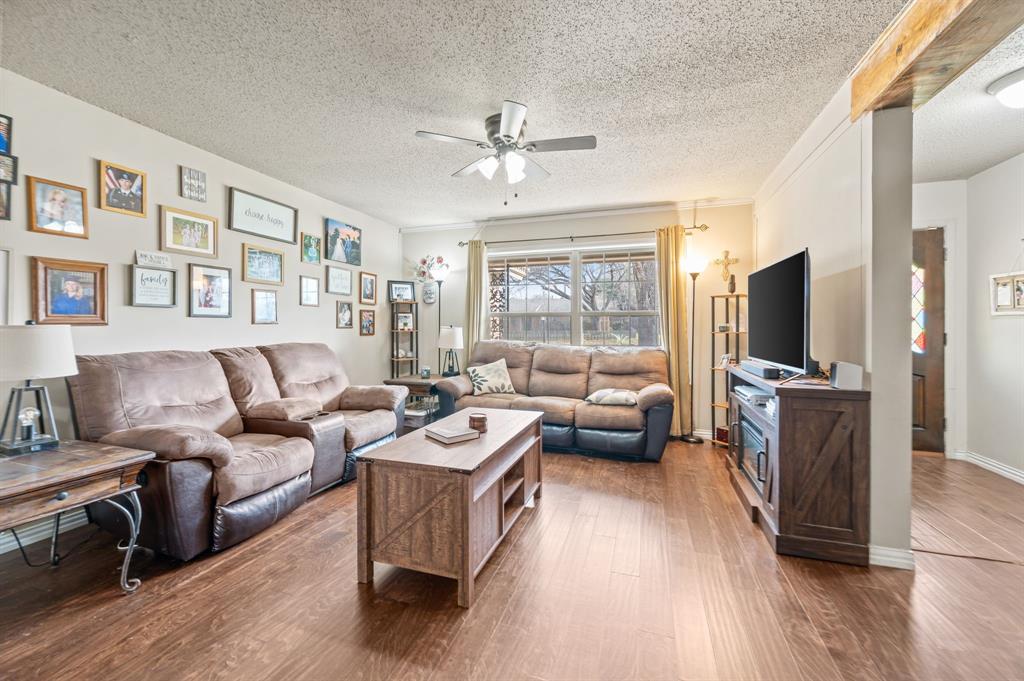 2125 Shady Brook Drive Bedford, TX 76021 - Photo 3 of 24 a living room with furniture a flat screen tv and a large window