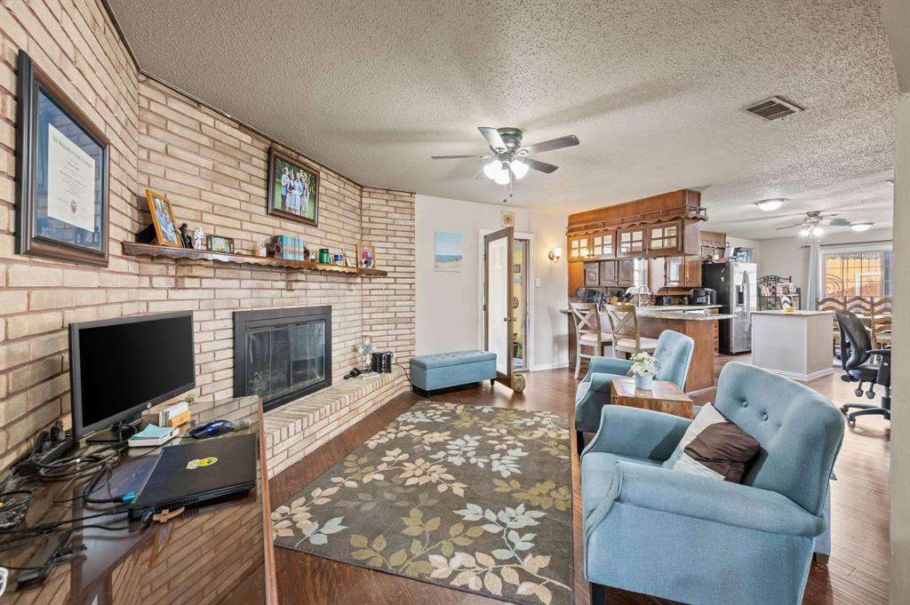 2125 Shady Brook Drive Bedford, TX 76021 - Photo 6 of 24 a living room with furniture and a fireplace