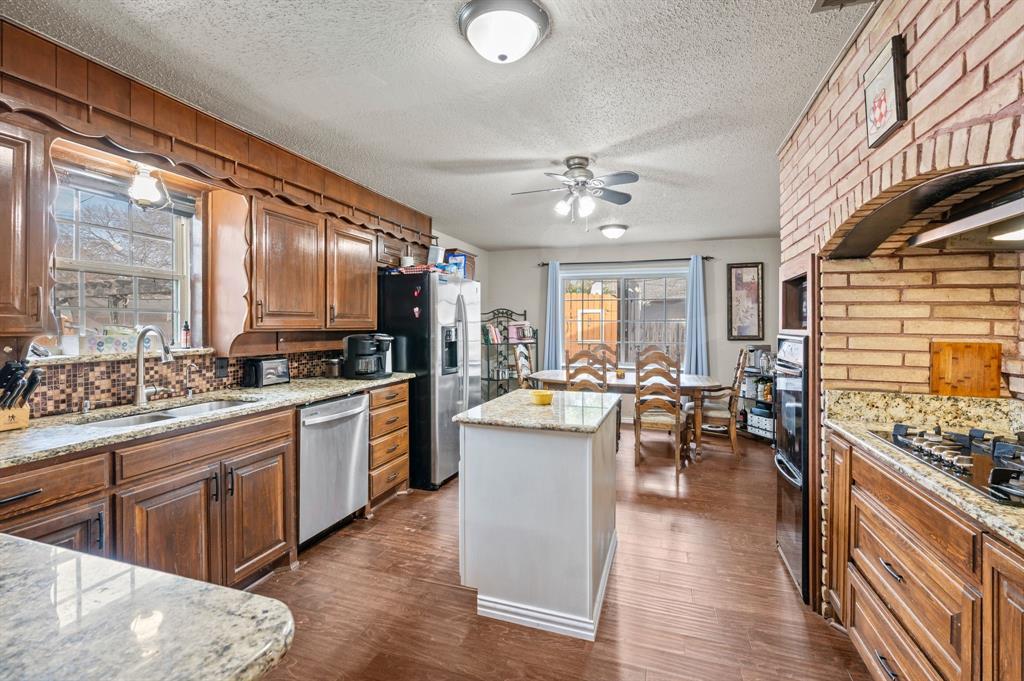 2125 Shady Brook Drive Bedford, TX 76021 - Photo 7 of 24 a large kitchen with kitchen island a large island in the center