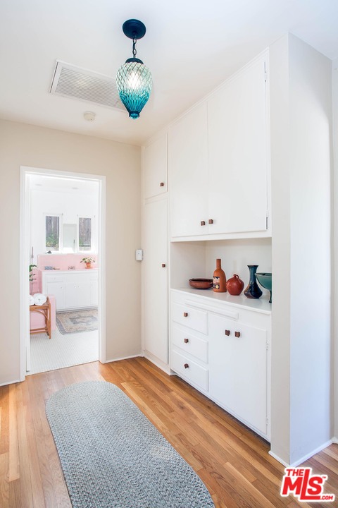 1081 Alta Pine Drive Altadena, CA 91001 - Photo 11 of 38 a bedroom with a bed and cabinets