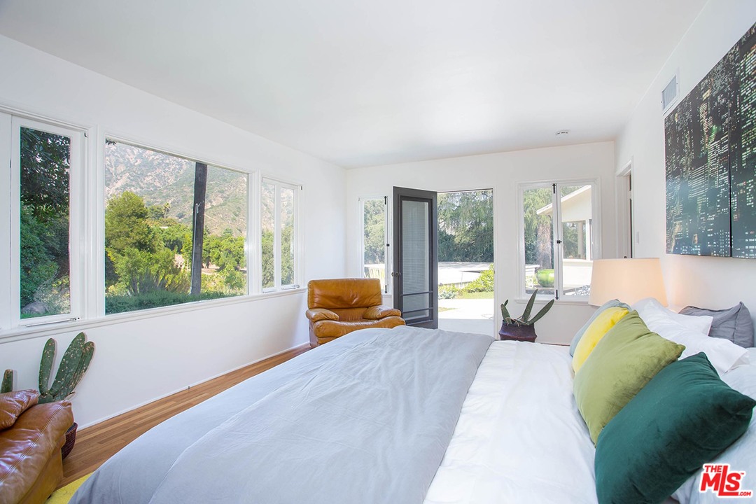 1081 Alta Pine Drive Altadena, CA 91001 - Photo 13 of 38 a bedroom with furniture and large windows