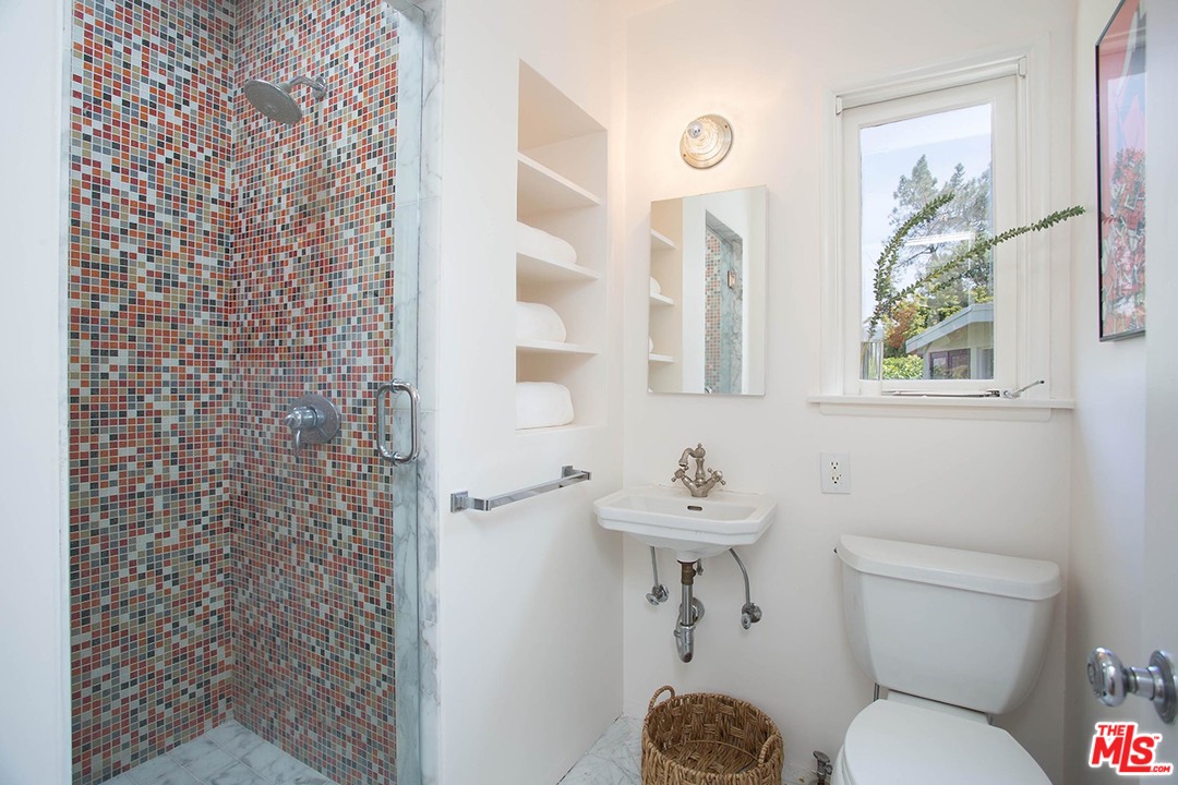 1081 Alta Pine Drive Altadena, CA 91001 - Photo 14 of 38 a bathroom with a toilet sink and mirror