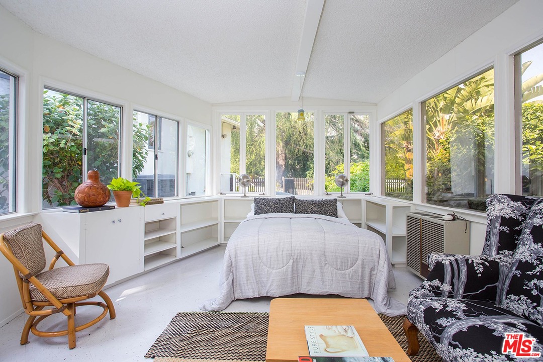 1081 Alta Pine Drive Altadena, CA 91001 - Photo 19 of 38 a bed room with a bed and large windows