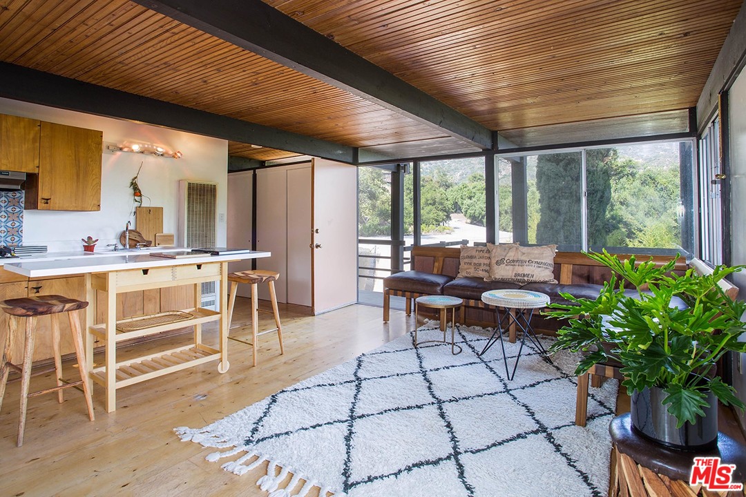 1081 Alta Pine Drive Altadena, CA 91001 - Photo 25 of 38 a living room with furniture a potted plant and a large window