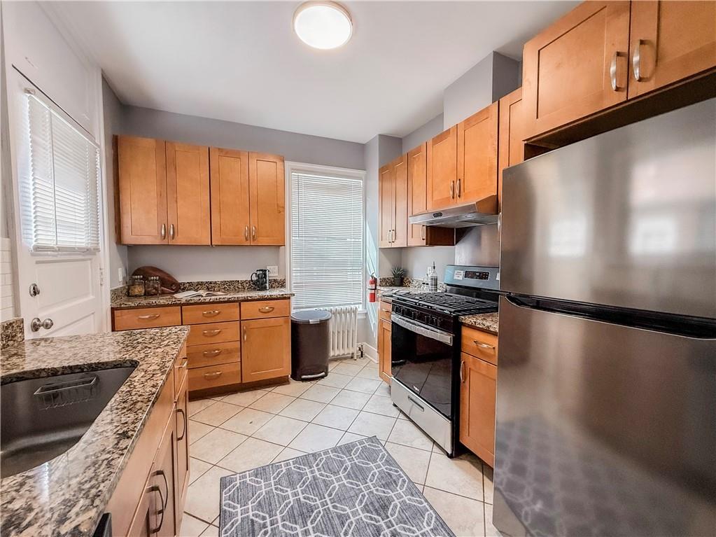 5642 Solway Street Pittsburgh, PA 15217 - Photo 13 of 28 a kitchen with stainless steel appliances granite countertop a stove a sink and a refrigerator