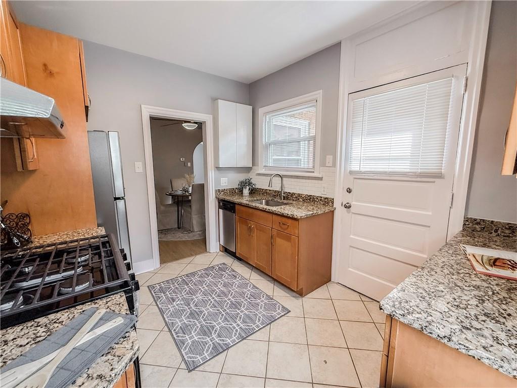 5642 Solway Street Pittsburgh, PA 15217 - Photo 15 of 28 a kitchen with stainless steel appliances granite countertop a stove a sink and a refrigerator