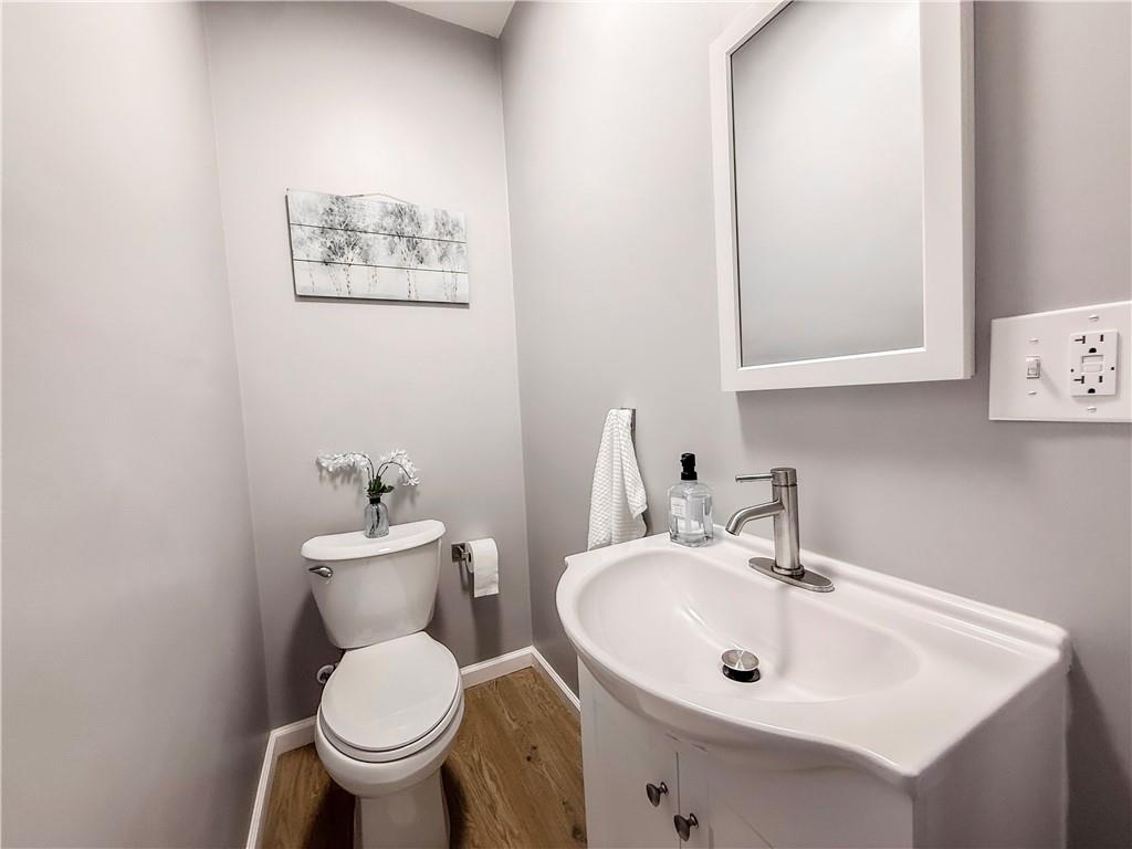 5642 Solway Street Pittsburgh, PA 15217 - Photo 16 of 28 a bathroom with a toilet sink and mirror