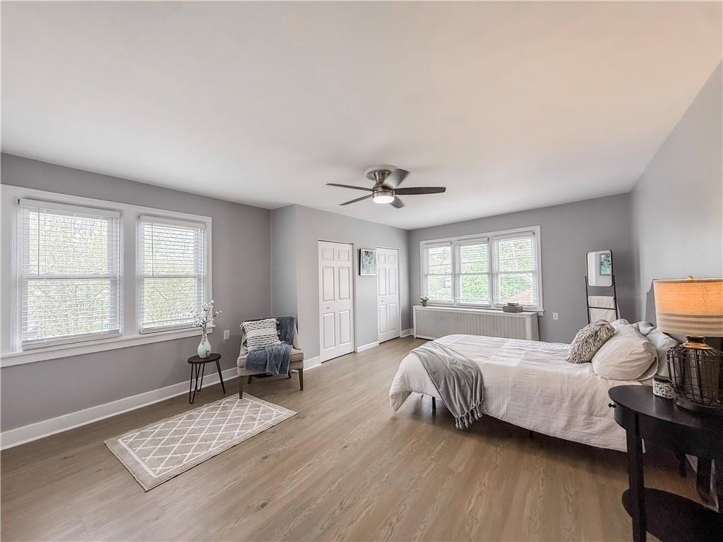 5642 Solway Street Pittsburgh, PA 15217 - Photo 17 of 28 a bedroom with a bed couch and window