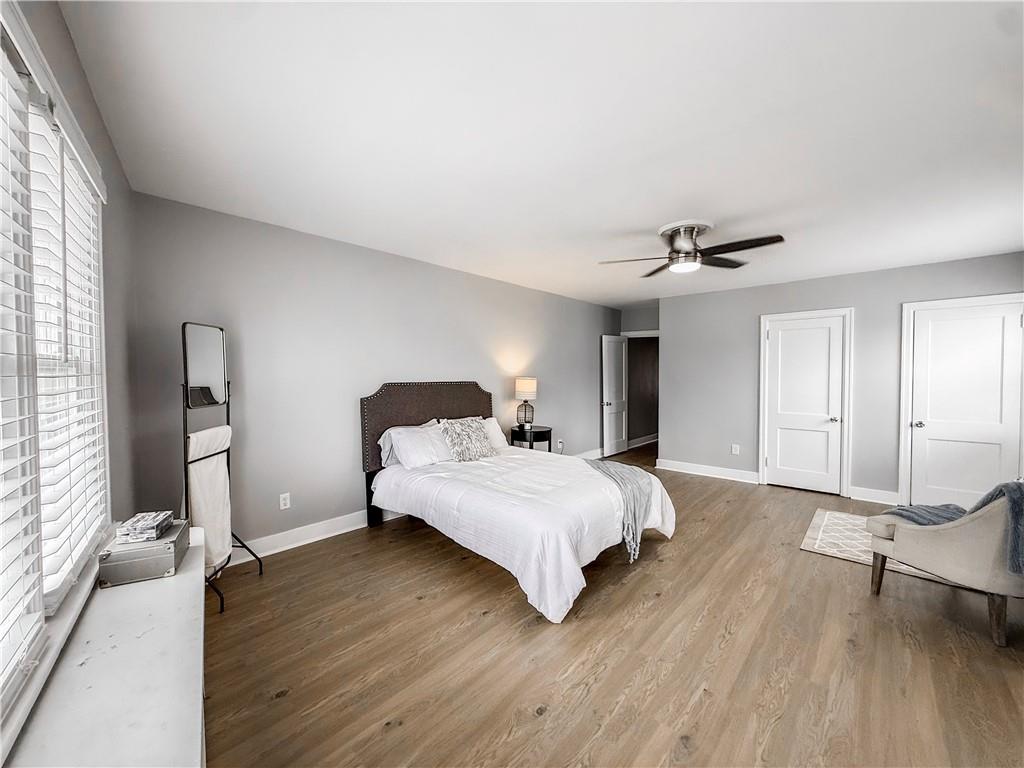 5642 Solway Street Pittsburgh, PA 15217 - Photo 18 of 28 a bedroom with a bed and wooden floor