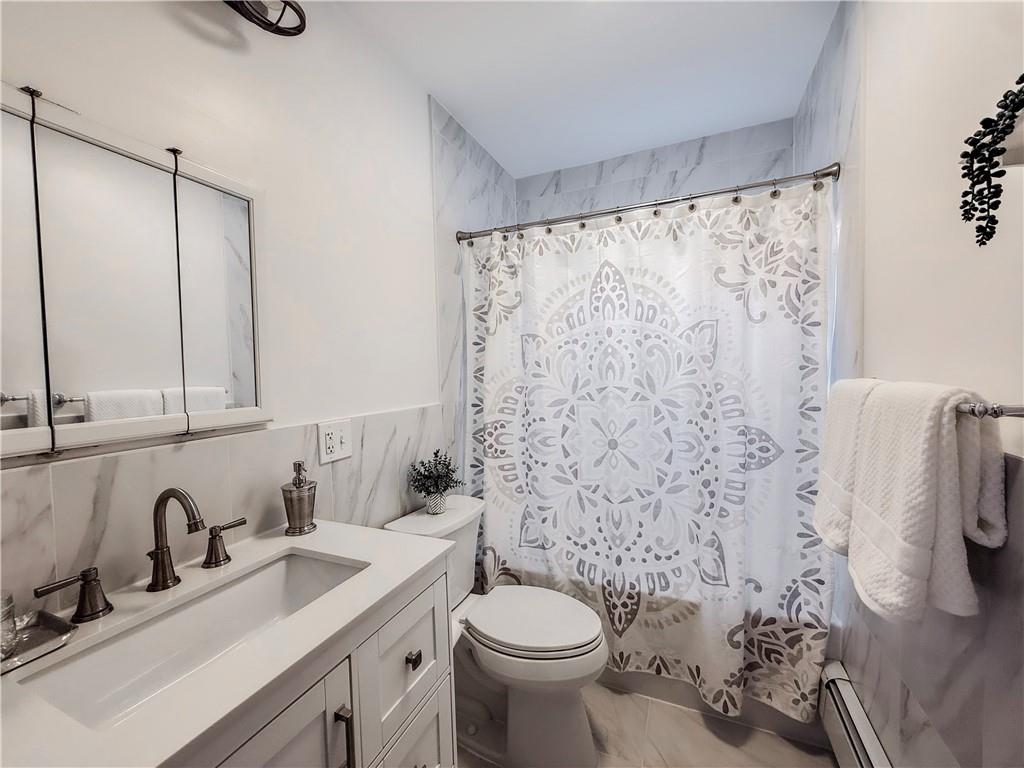 5642 Solway Street Pittsburgh, PA 15217 - Photo 20 of 28 a bathroom with a sink toilet and shower