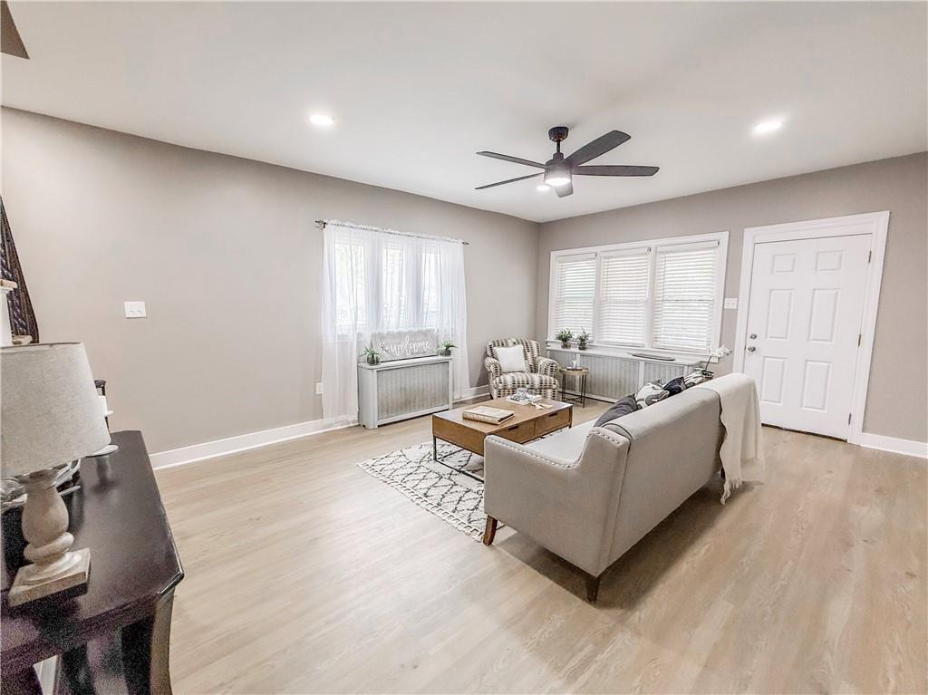 5642 Solway Street Pittsburgh, PA 15217 - Photo 5 of 28 a living room with furniture and a chandelier