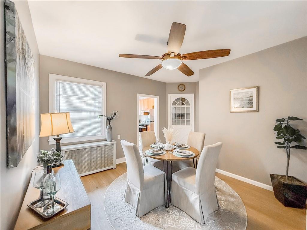 5642 Solway Street Pittsburgh, PA 15217 - Photo 9 of 28 a dining room with furniture a chandelier and wooden floor
