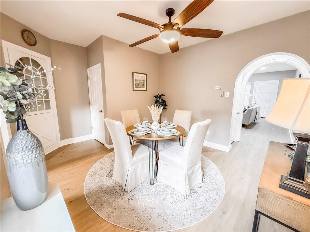 5642 Solway Street Pittsburgh, PA 15217 - Photo 10 of 28 a dining room with wooden floor a chandelier a wooden table and chairs