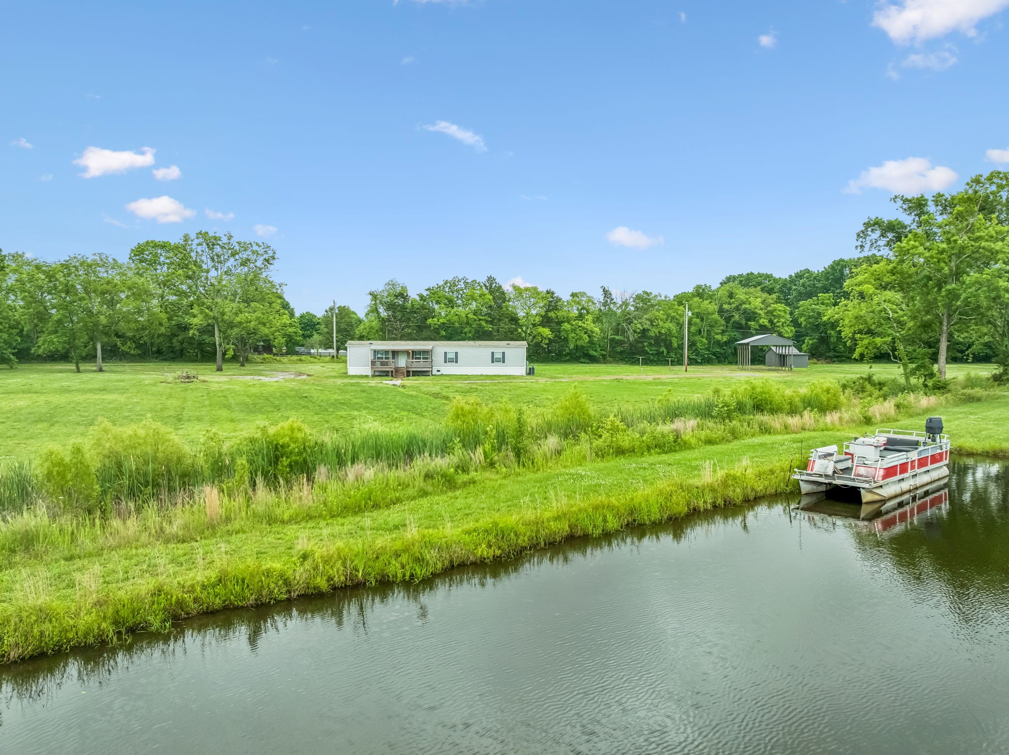 280 Kingdom Road Unionville, TN 37180 - Photo 40 of 65 a view of a lake with houses in the background