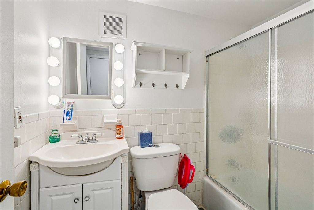 208 Swanson Road, Unit 526 Boxborough, MA 01719 - Photo 11 of 18 a bathroom with a sink toilet vanity and shower