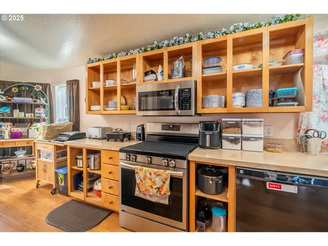 a kitchen with stainless steel appliances granite countertop a stove and cabinets