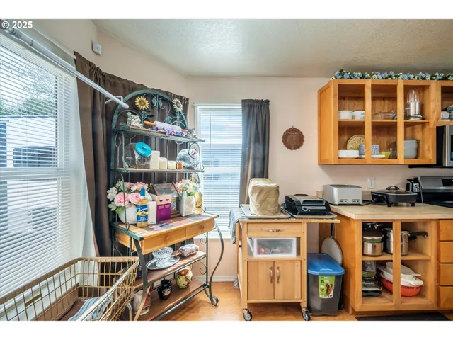a picture of a living room with a baby crib furniture and a window