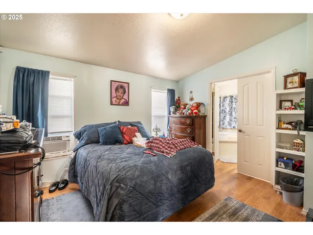 a bedroom with a bed and a book shelf